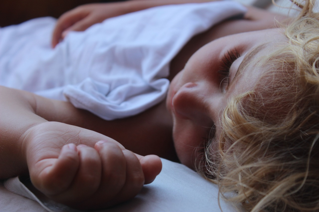 child having a snooze in bed