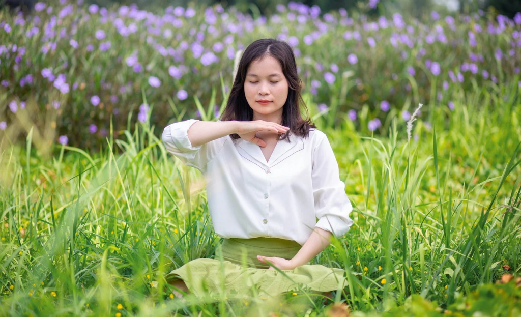 woman meditating in a field