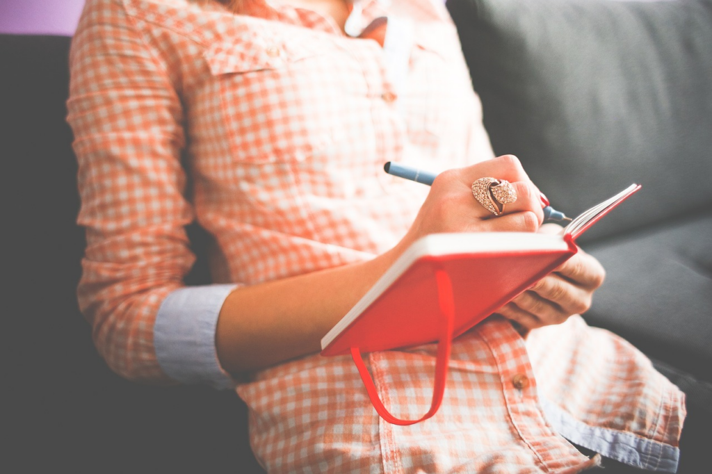 person writing in a journal