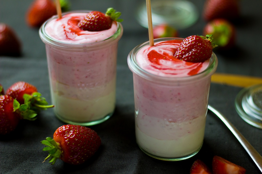 yogurt cups with strawberries on them
