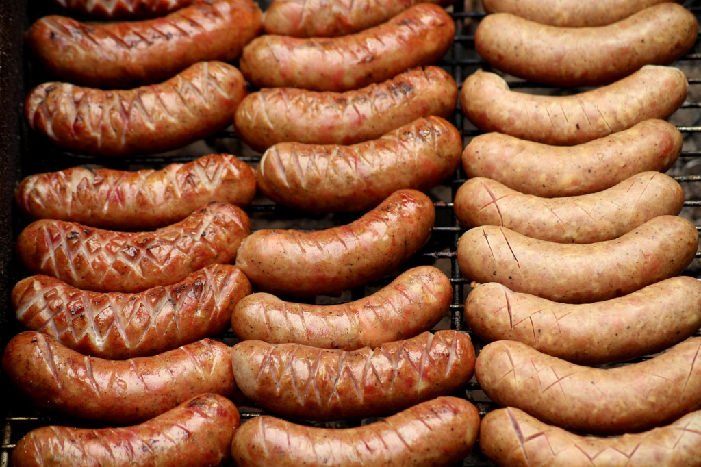 sausages lined up on a grill