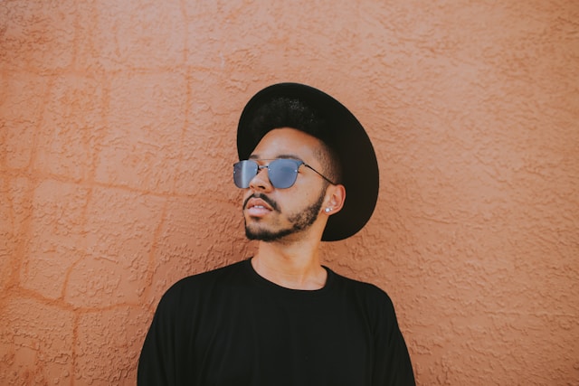 a man in a hat and sunglasses