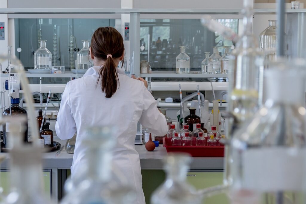 A medical professional in the lab. Lab equipment in the background. 