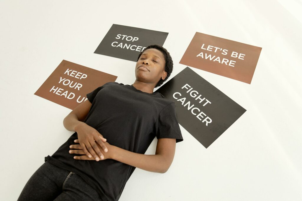 Woman lying beside Placards signs of cancer