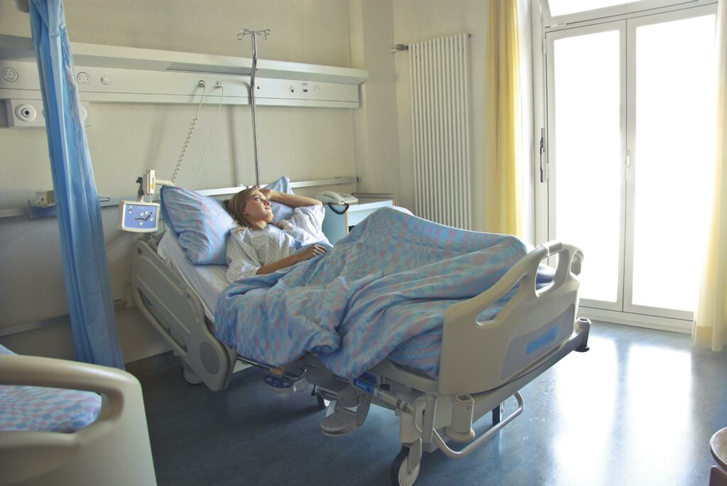 Photo of Woman Lying in Hospital Bed
