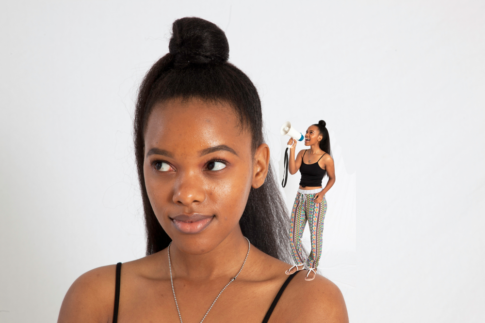 Pretty Black woman talking to herself with a megaphone, and not listening