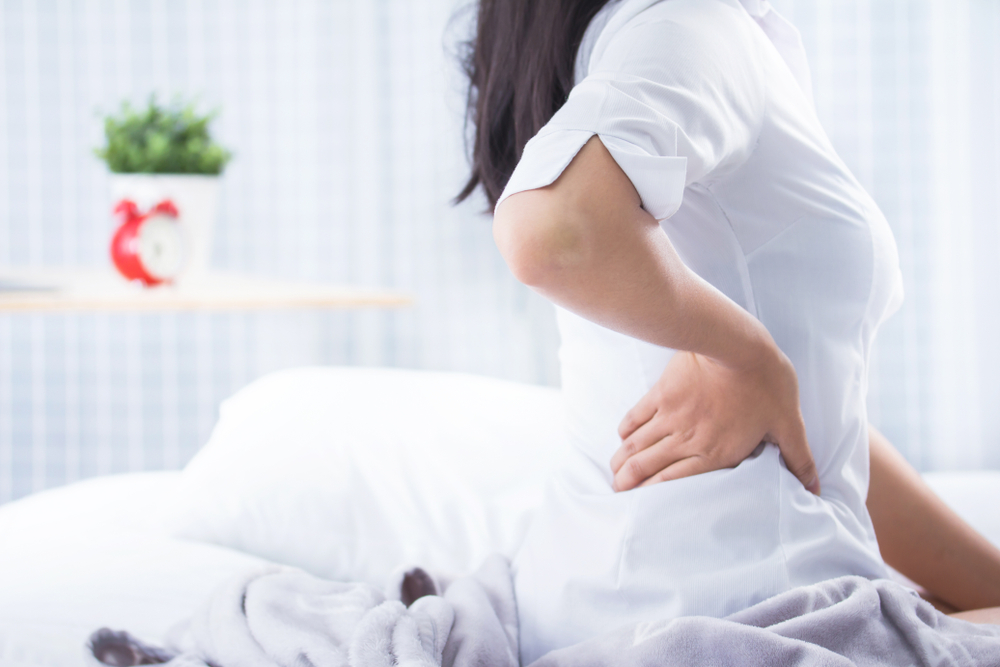 Woman problem Chronic back pain on bed morning time