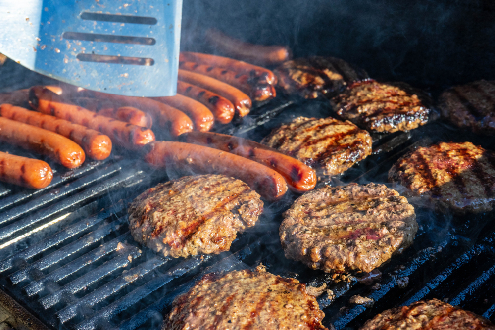 Hot Dogs and Hamburgers sizzling on the grill. Summertime at it's greatest.