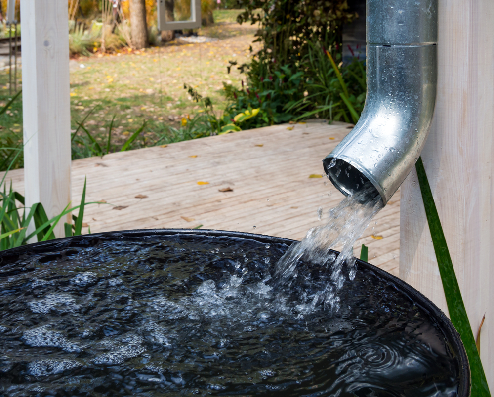 Water drains from the drain pipe into a metal container
