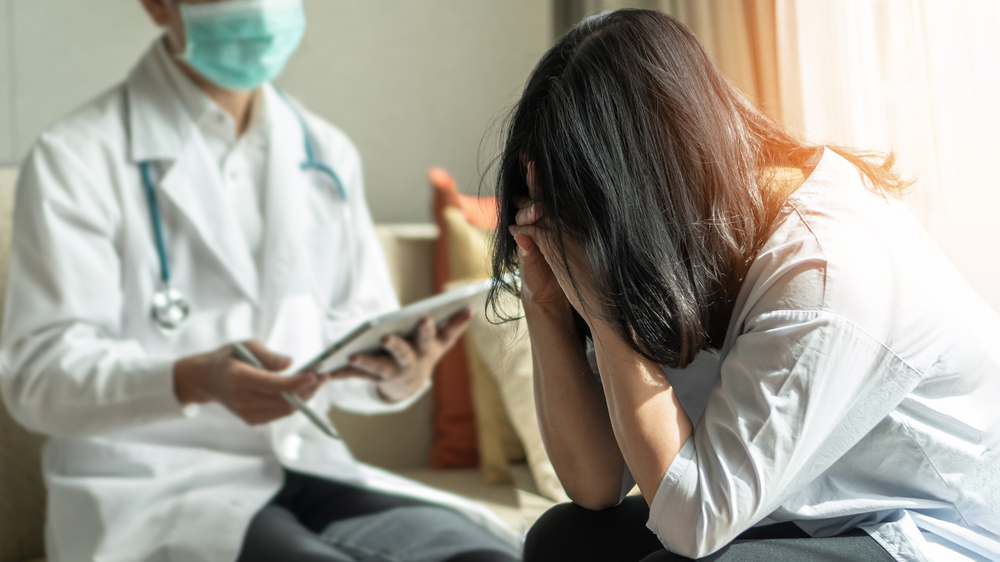 Panic attack menopause woman, stressful depressed PTSD patient with anxiety disorder having consultation psychotherapy treatment session in doctor clinic or psychologist counselor office
