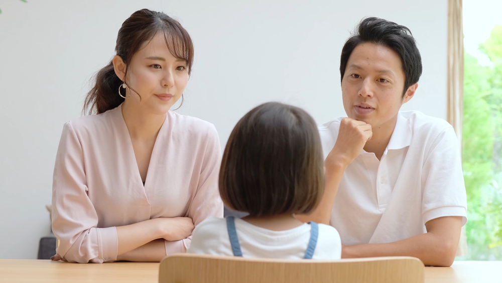 young japanese family discussing in the living room