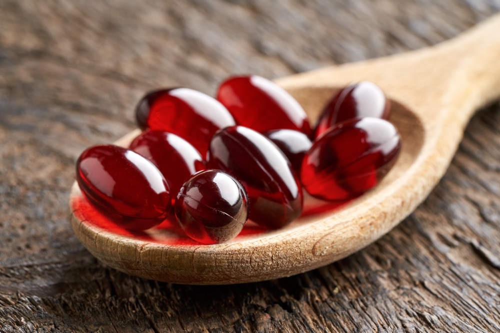 Krill oil pills on a spoon, closeup
