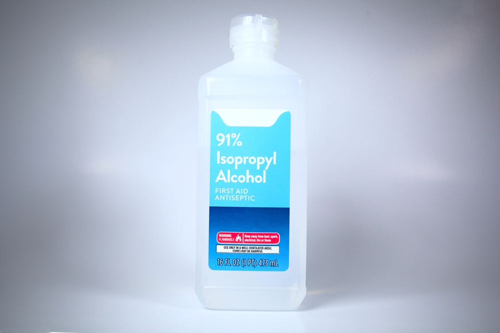 Isolated plastic bottle of 91% isopropyl alcohol with label
