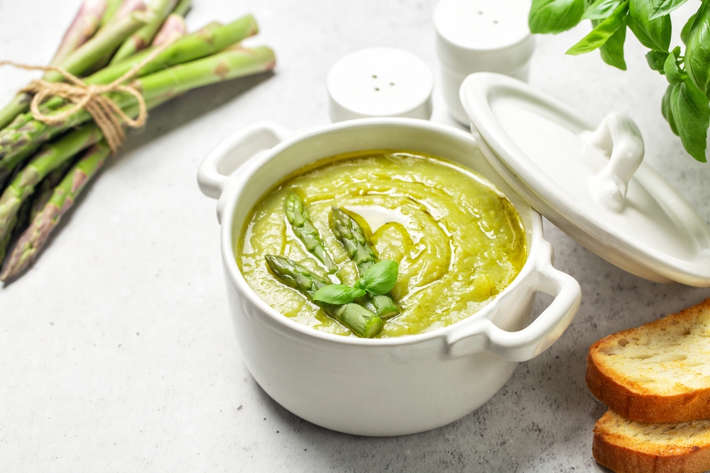 Cream of asparagus soup. Prepared with asparagus, potato, onion and vegetable stock. Uncooked ingredient on bacground. Vegan.