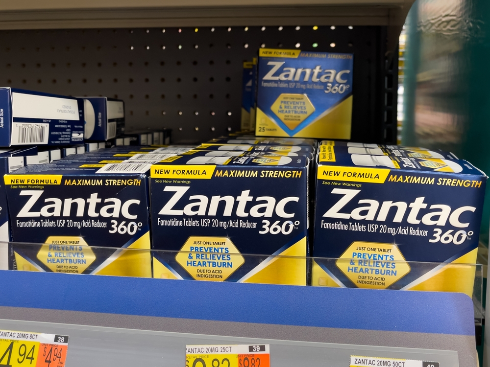 ATLANTA, GEORGIA - AUGUST 14, 2022 : Zantac heartburn relief acid reducer tablets on shelf at drug store pharmacy.