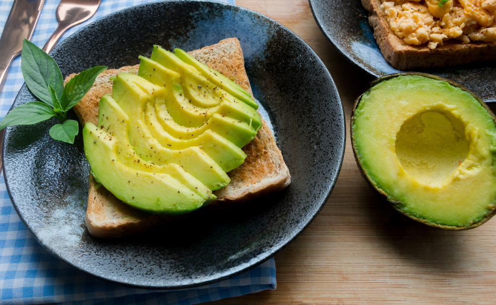 Healthy avocado toasts for breakfast. sliced avocado, salt and pepper. Whole food concept.
