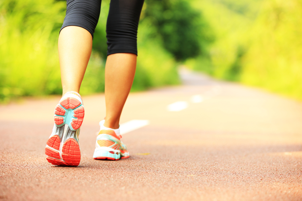 young fitness woman hiker legs at forest trail
