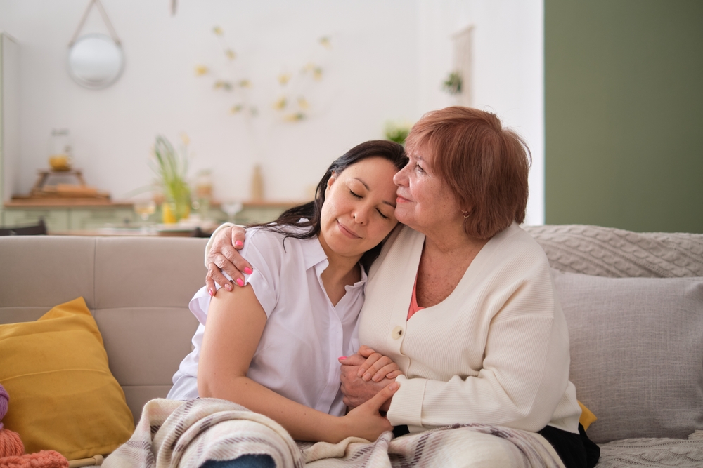 tender image of an elderly mother and her adult daughter emphasizes the emotional aspects of aging in place, discussing how families can work together to ensure comfort and safety of their loved one