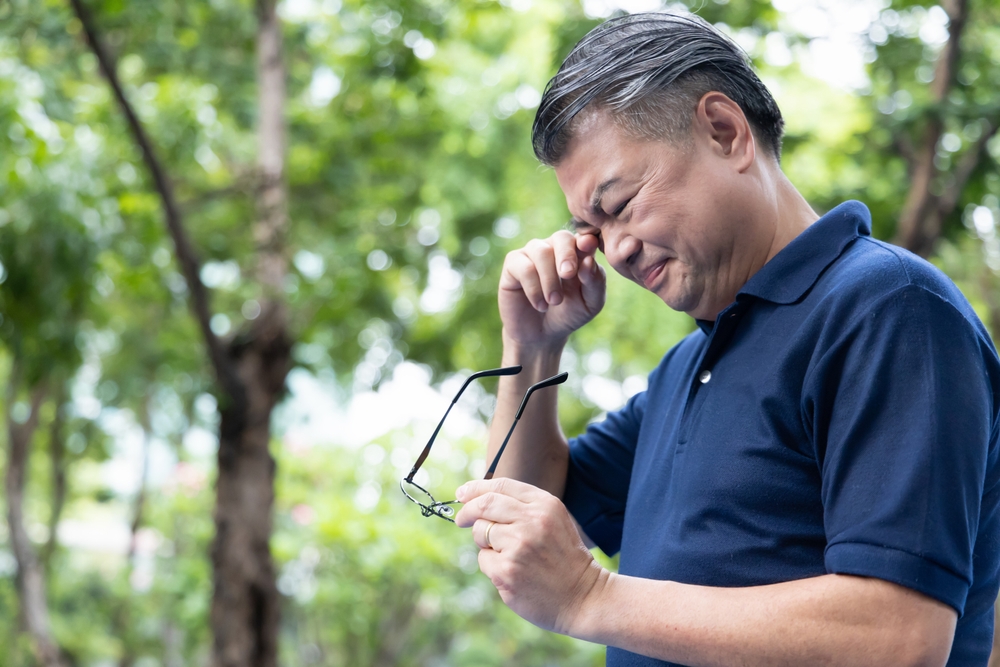 Senior Asian Man holding unfit glasses, Struggling with Eyesight Problem, Eye Health Concept