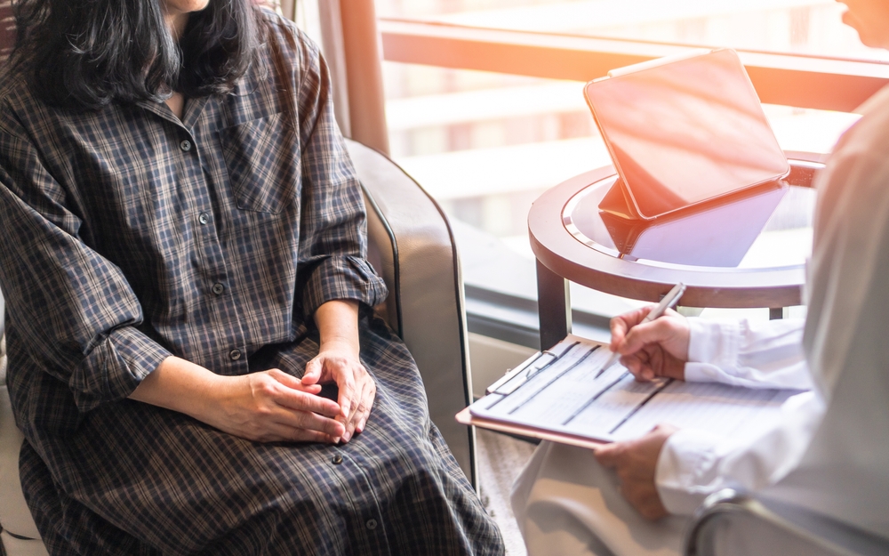 Menopause woman, stressful patient consulting with doctor or psychiatrist counselor who diagnostic examining on mental health illness or obstetric - gynaecological disorder in medical clinic office