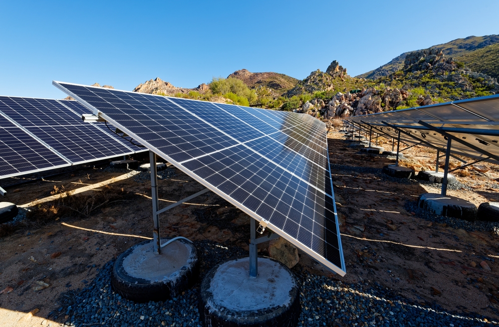 Solar panels anchored in old car tires on a farm near Worcester, Western Cape, South Africa
