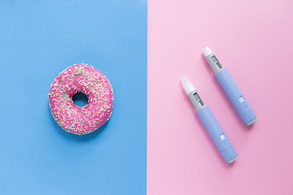 Delicious sweet pink donut on a blue background and two Ozempic pen injections on a pink background. Sugar and medicana, concept. Weight loss. subcutaneous injection of antidiabetic medication
