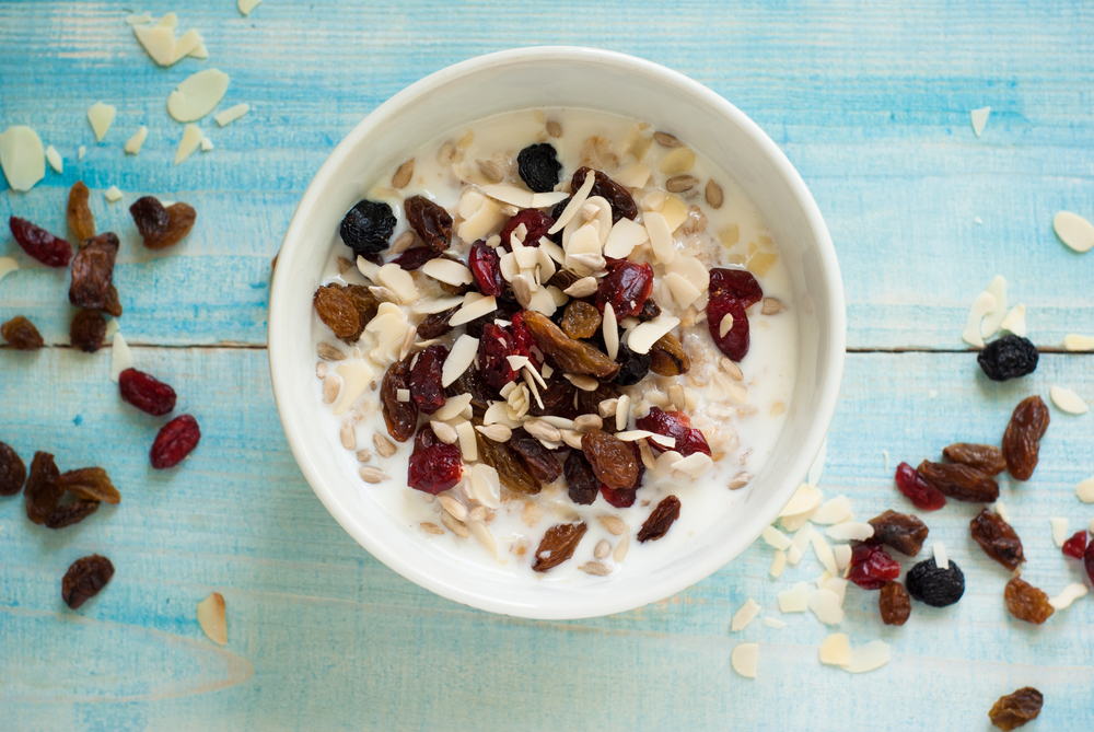 Healthy Breakfast - Oatmeal with dried fruit at blue table