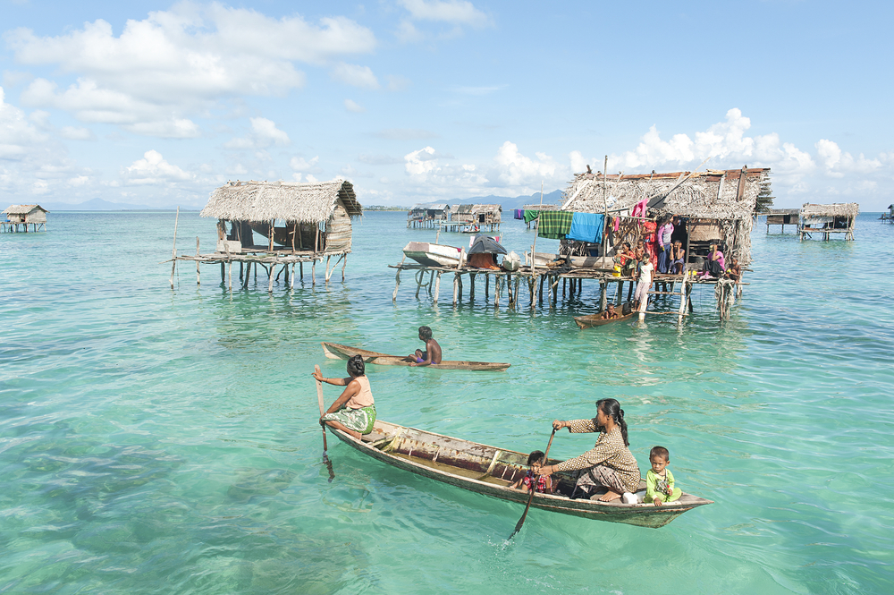 Sabah, Malaysia-May 03, 2013:Unidentified Borneo Sea Gypsy peoples on a canoes in Mabul Maiga Island, Sabah Borneo, Malaysia. They living on long boats know as lepa lepa in the middle of ocean.