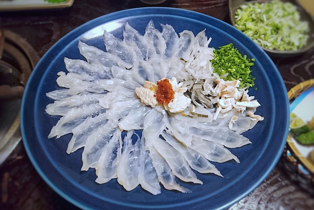 Raw Puffer fish in blue dish

