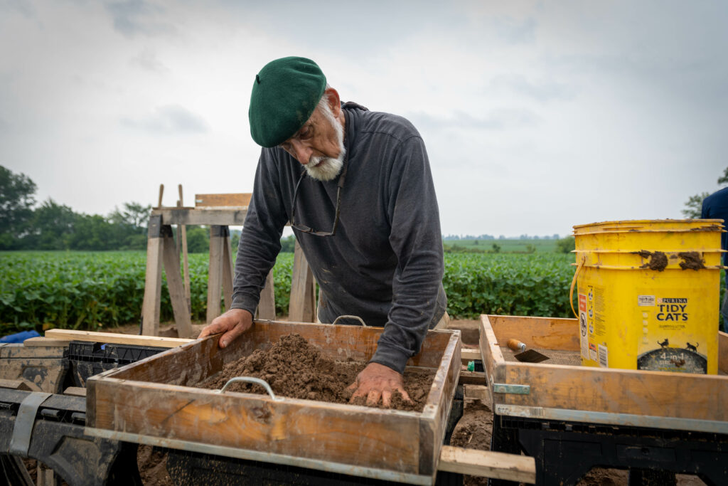 Older gentleman working through ancient dirt