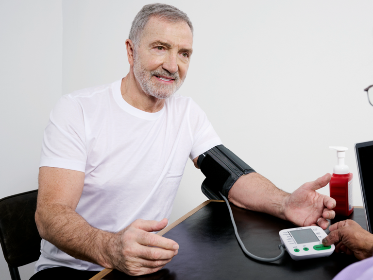 Graeme Souness getting his blood pressure checked 