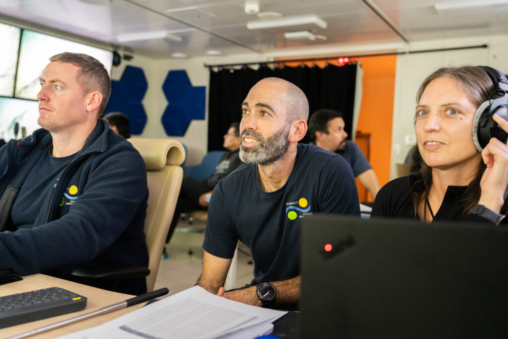 Marine Technician and Expedition Co-Chief Scientist Tomer Ketter, supervises Mission Control room monitors, together with ROV Supervisor Michael Rae, and Erin E. Easton, Assistant Professor in the School of Earth, Environmental, and Marine Sciences at the University of Texas Rio Grande Valley - UTRGV.