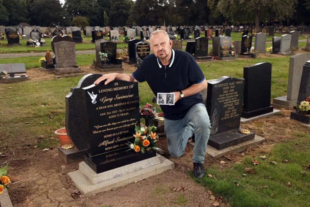 Picture of Russell Swinscoe at the the grave of Alfred Swinscoe.