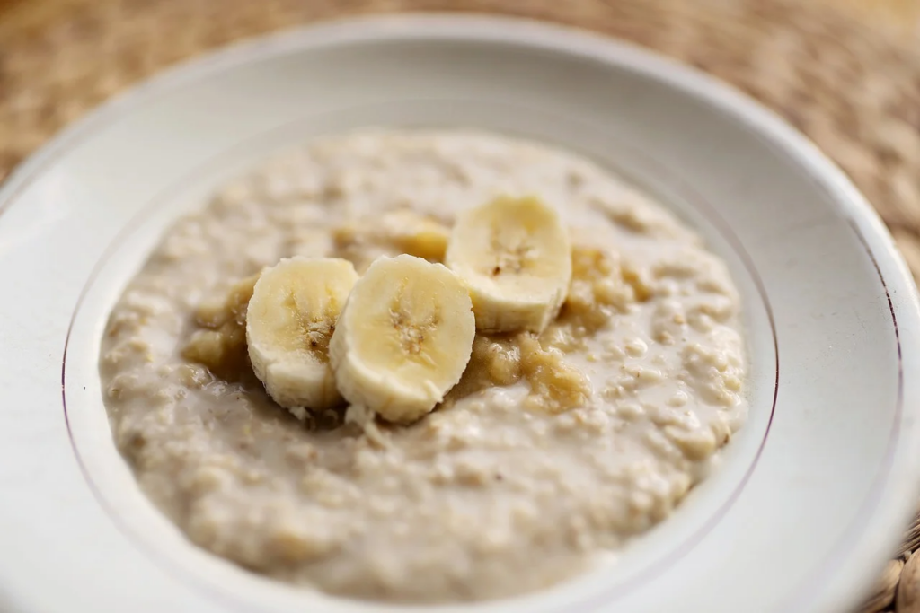 bowl of oatmeal with brown sugar and bananas