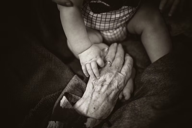 a very old and very young hand 