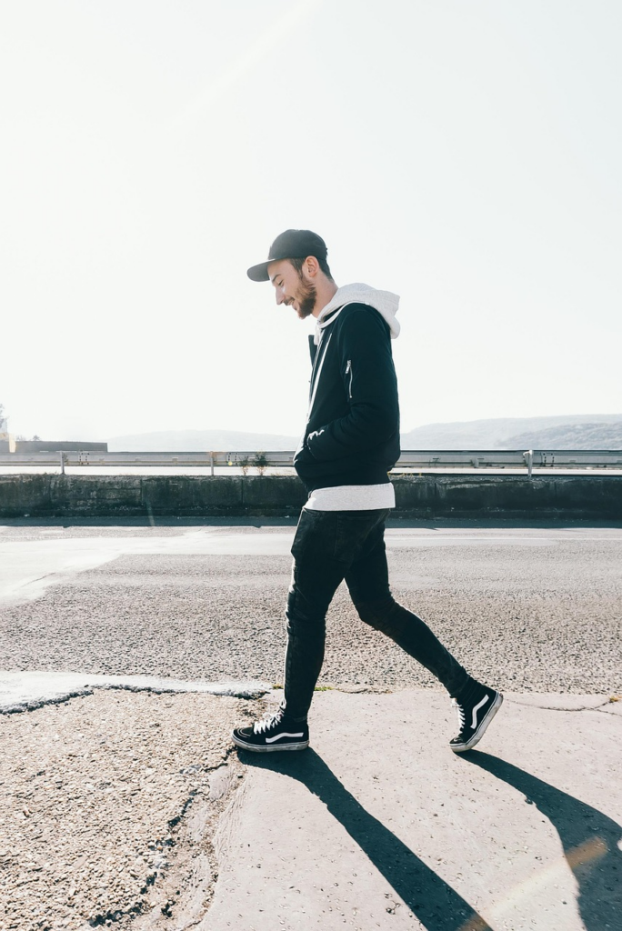 man walking along asphalt