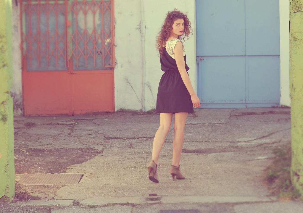 woman looking back mid stride in the street