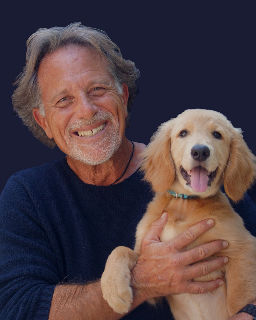 elder gentleman holding a puppy