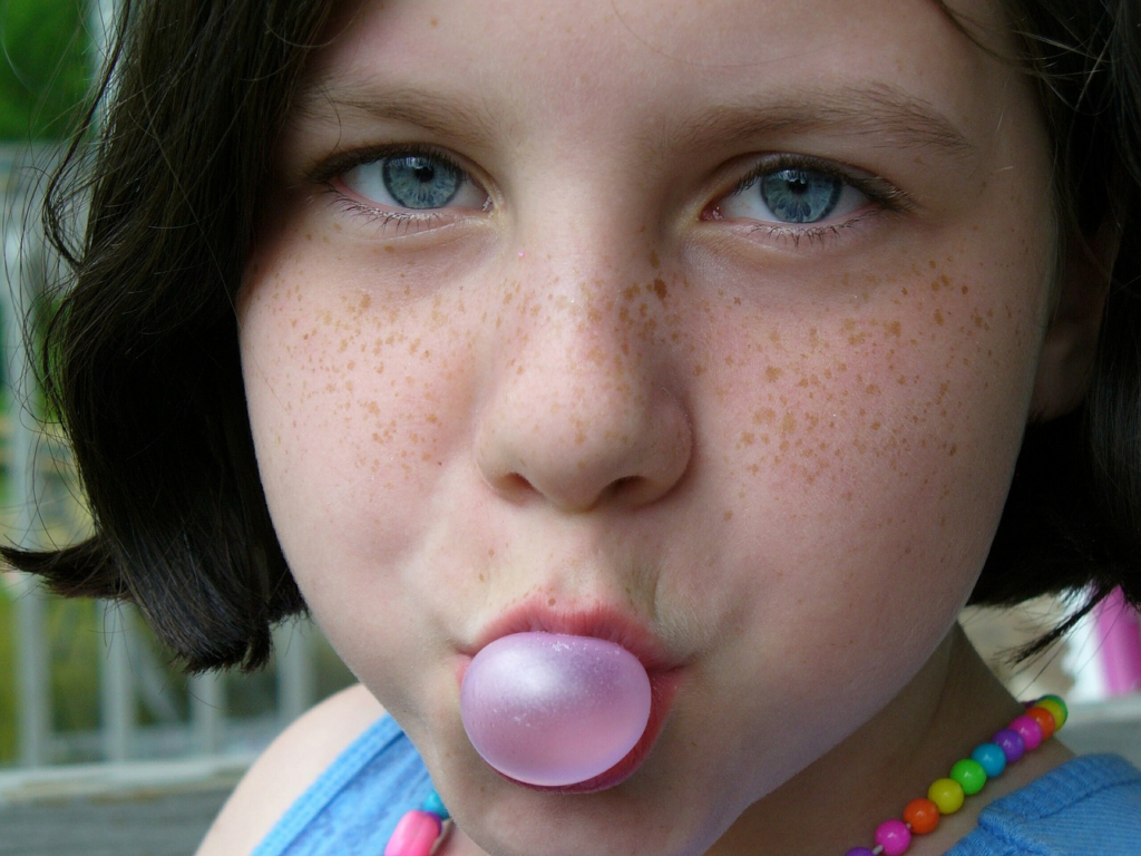 Young child blowing a bubble