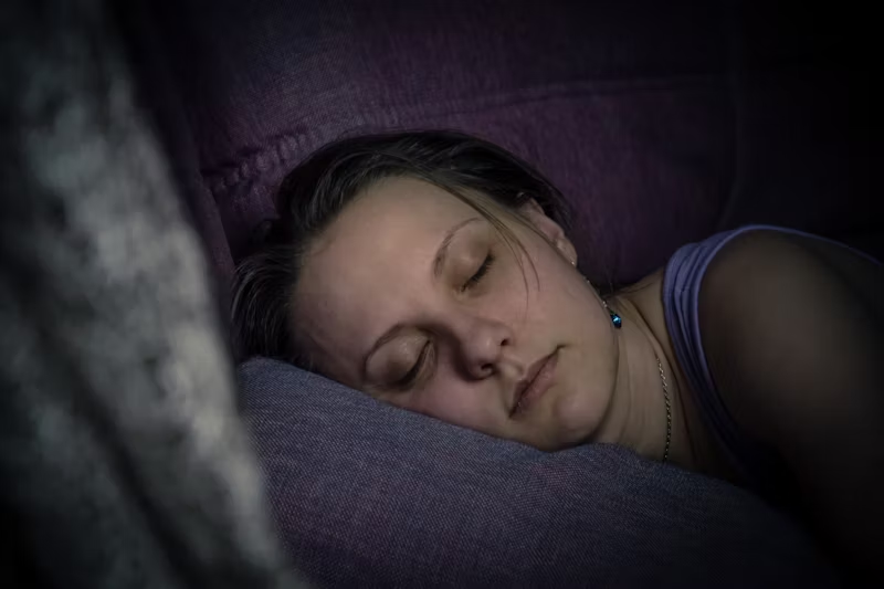 Woman laying asleep on pillow