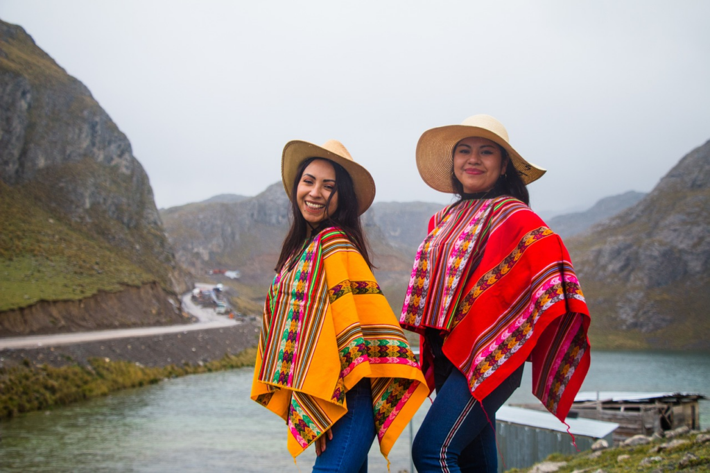 two women wearing ponchos