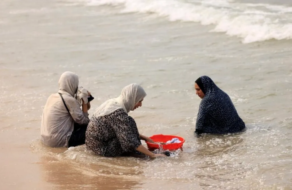 Palestinian women wash their clothes using sea water due to the lack of fresh water and electricity 