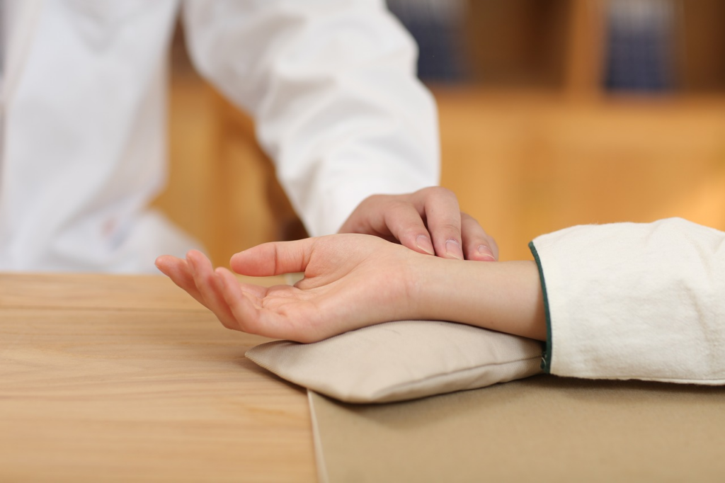 Doctor checking patient's pulse
