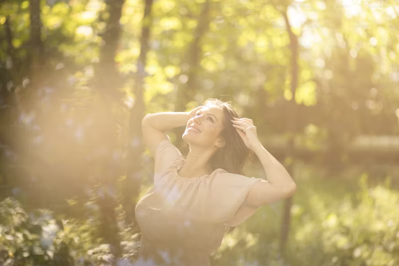happy woman in the wild with the sun shining