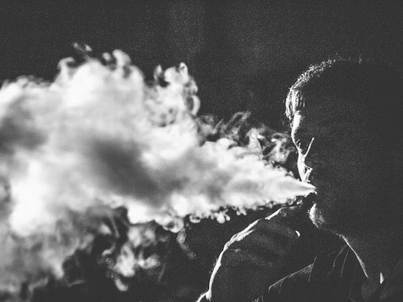 Man breathing out a lot of smoke
