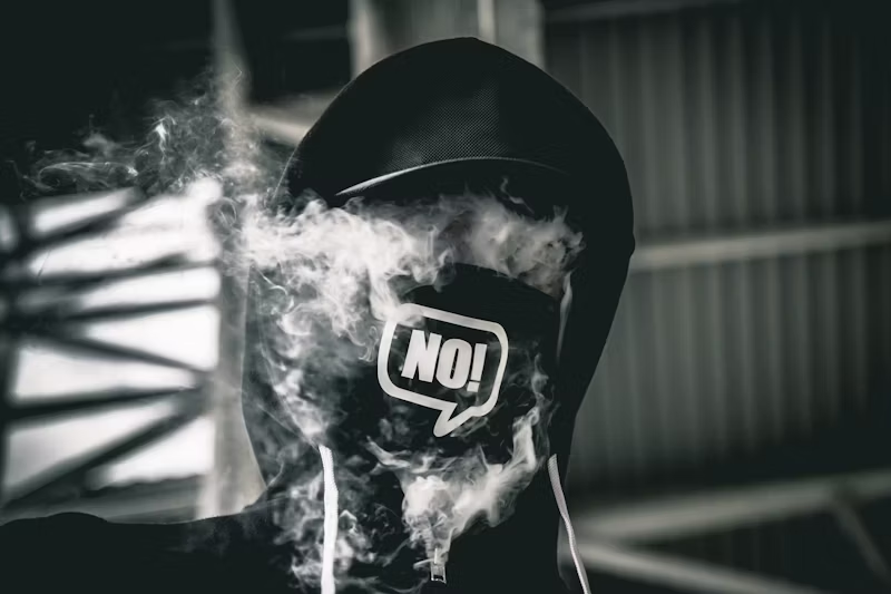 man in NO mask surrounded by smoke