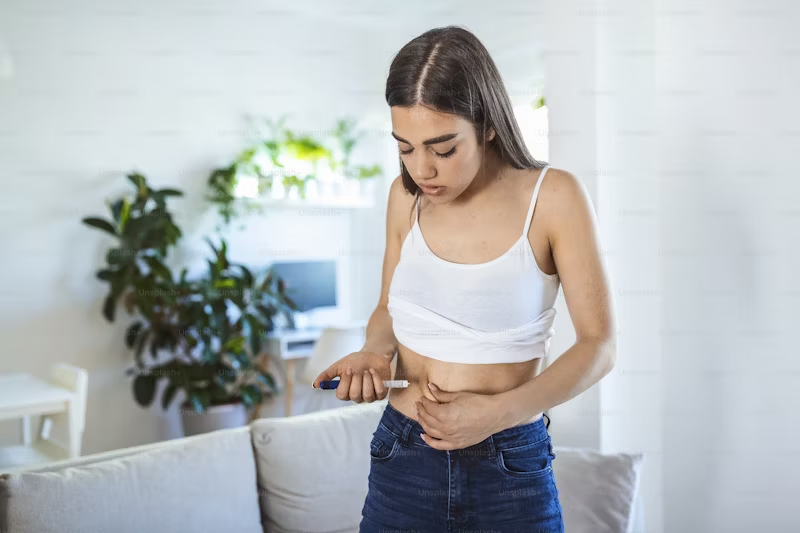 young woman taking an insulin shot