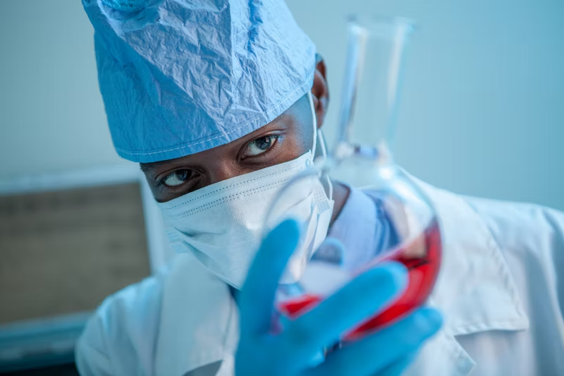 Doctor examining beaker 
