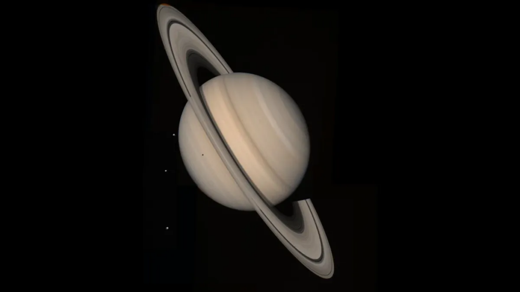 Saturn and three of its moons, Tethys, Dione and Rhea (from 13 million miles)