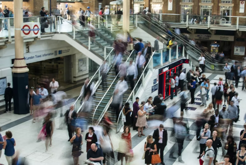 people moving in a blur through a building